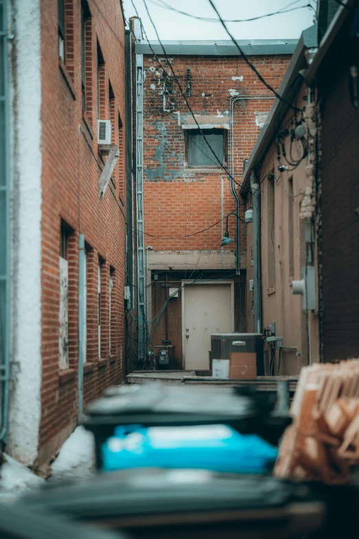 a street scene with brick buildings and trash