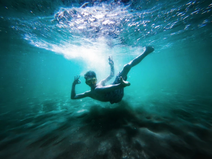 a person swimming under the water in a body of water