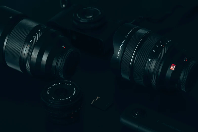 three lenses are stacked on top of a black camera