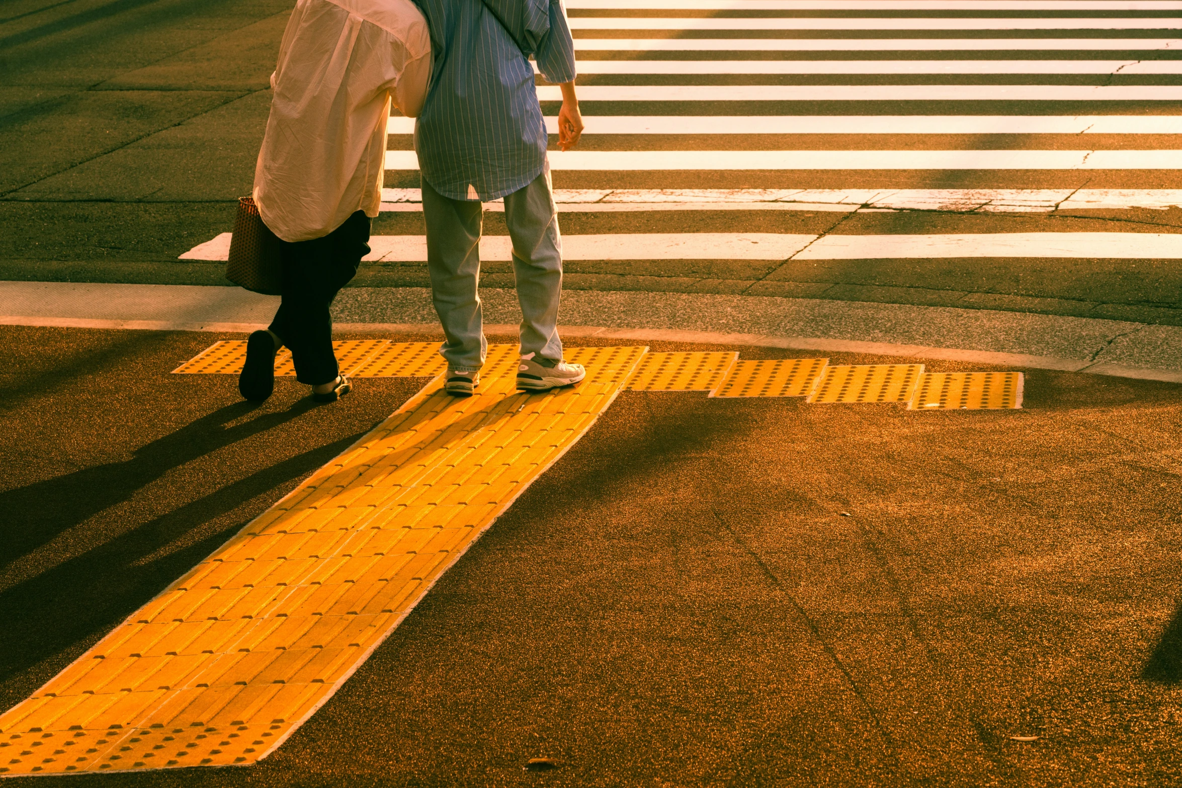 the woman has her head over the back of the suitcase on the cross walk