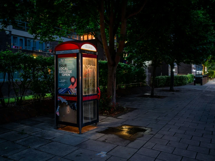 the bus stop is lit up on the street