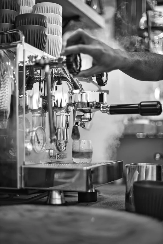 a black and white image of someone pours coffee