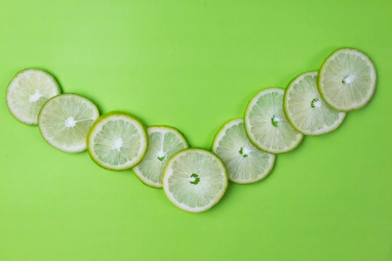 five lemon halves arranged in a group on a green background