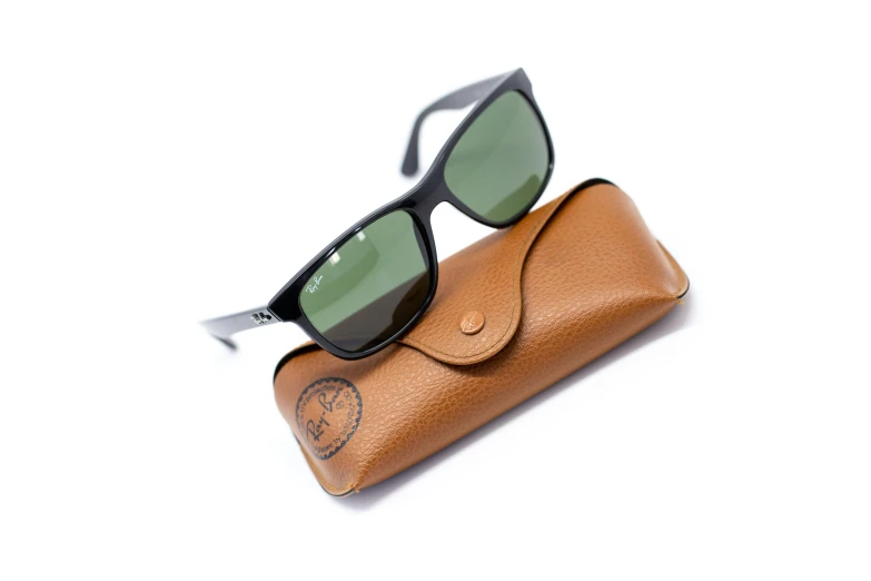 black ray bans are set on a tan pouch