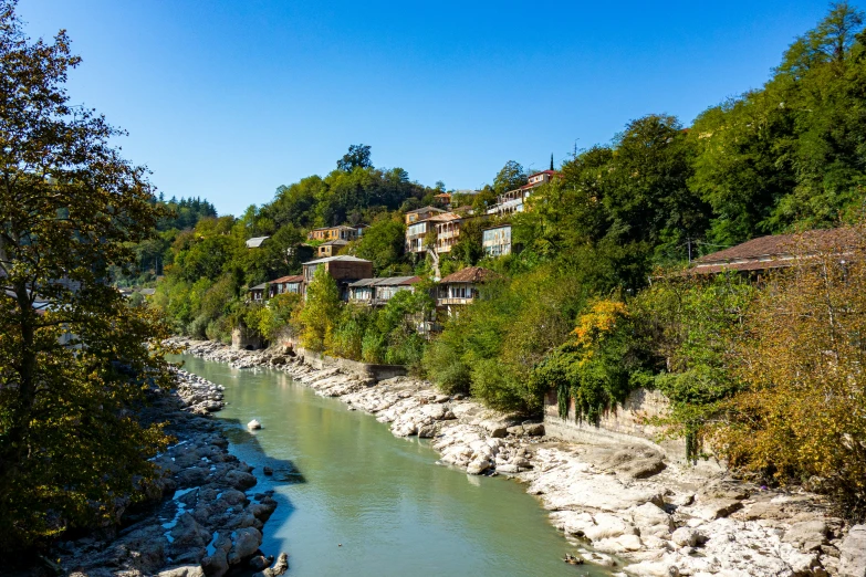 a beautiful small creek with a couple of houses on top of it