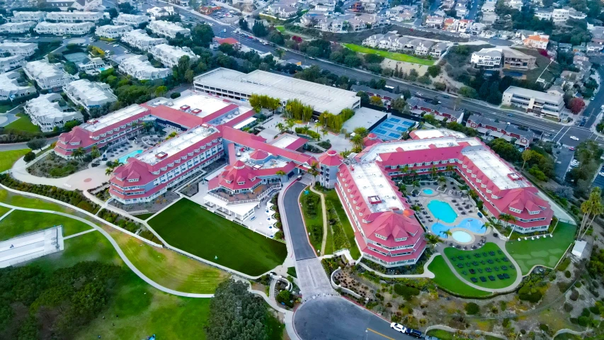 an aerial view of a building surrounded by trees and buildings