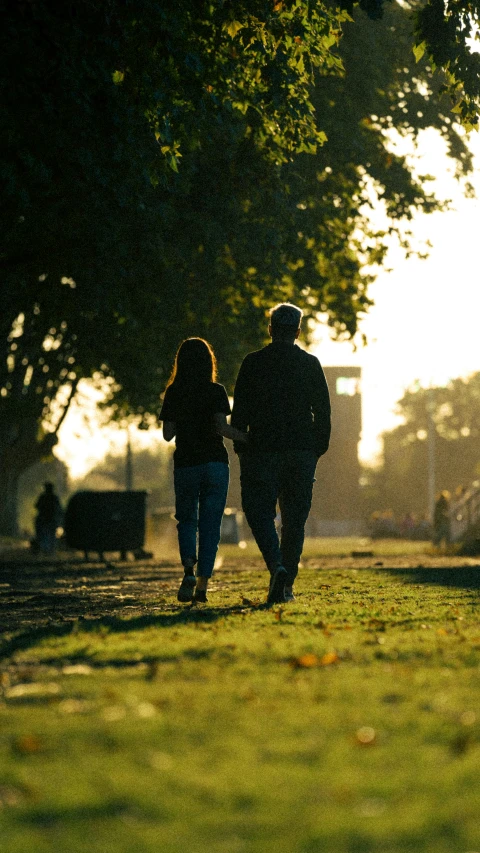 the man and woman are walking down the street