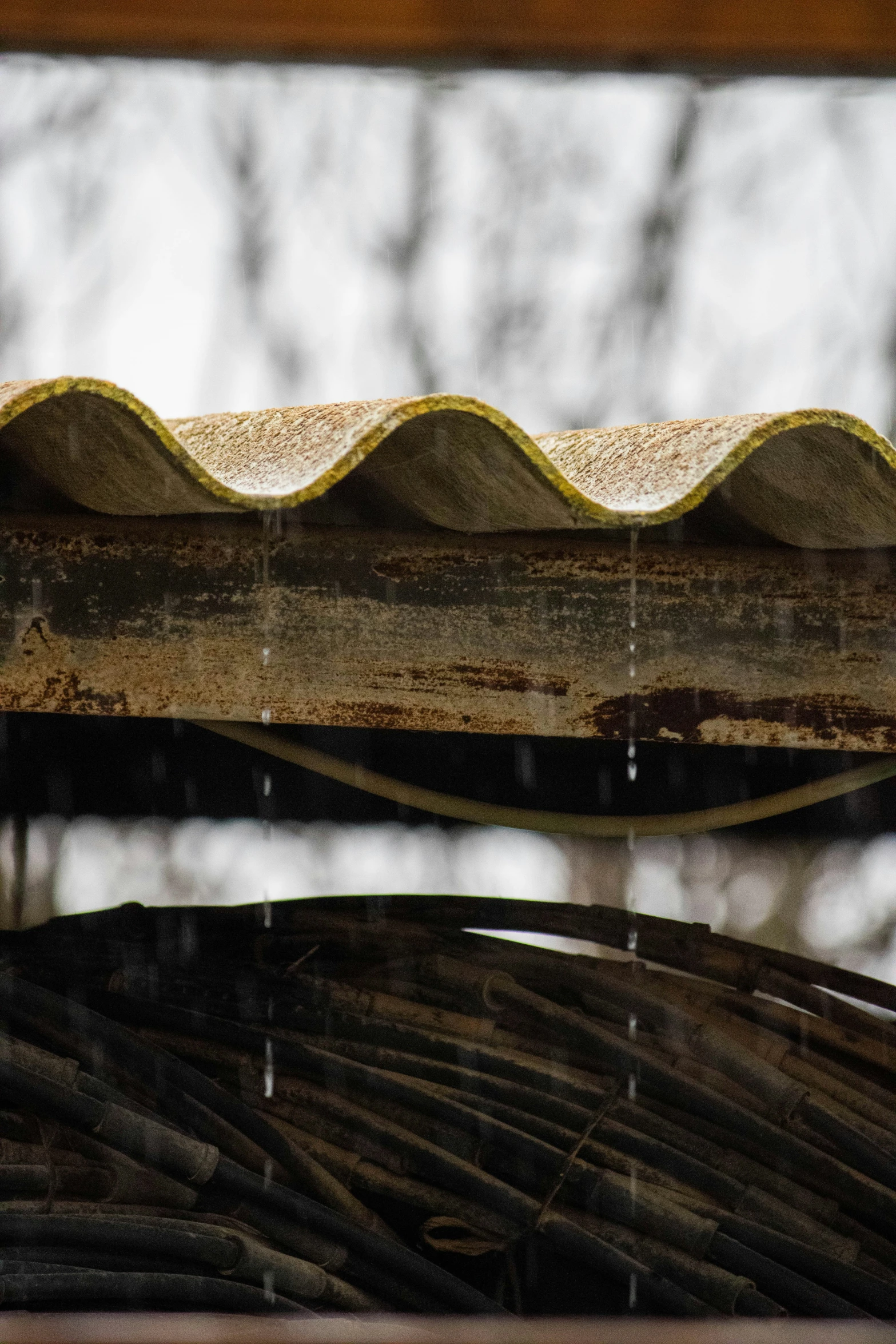 the roof of a structure that has rain dripping over it