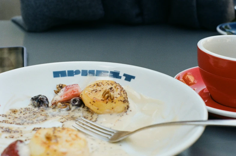 an english breakfast of fruits, nuts, and a  drink