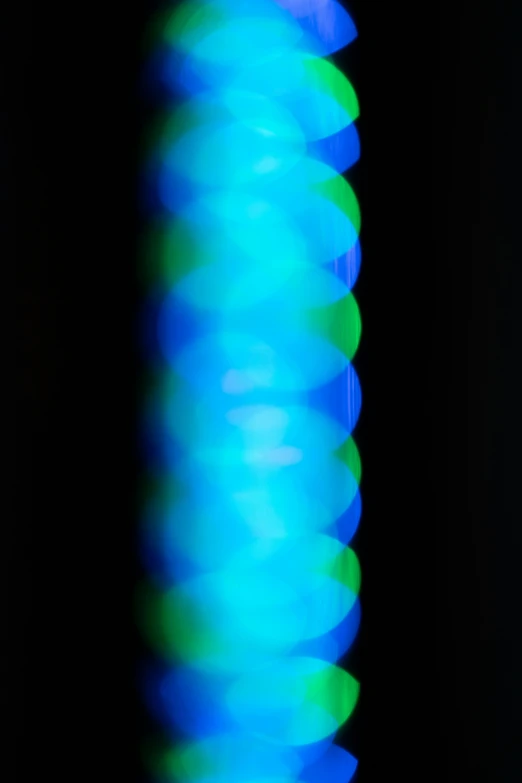 a blurry pograph of the bottom end of a blue cylinder