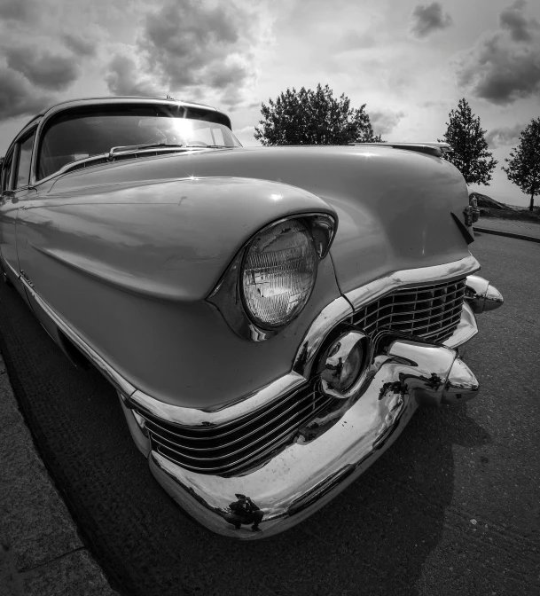 an old car is parked in a parking lot