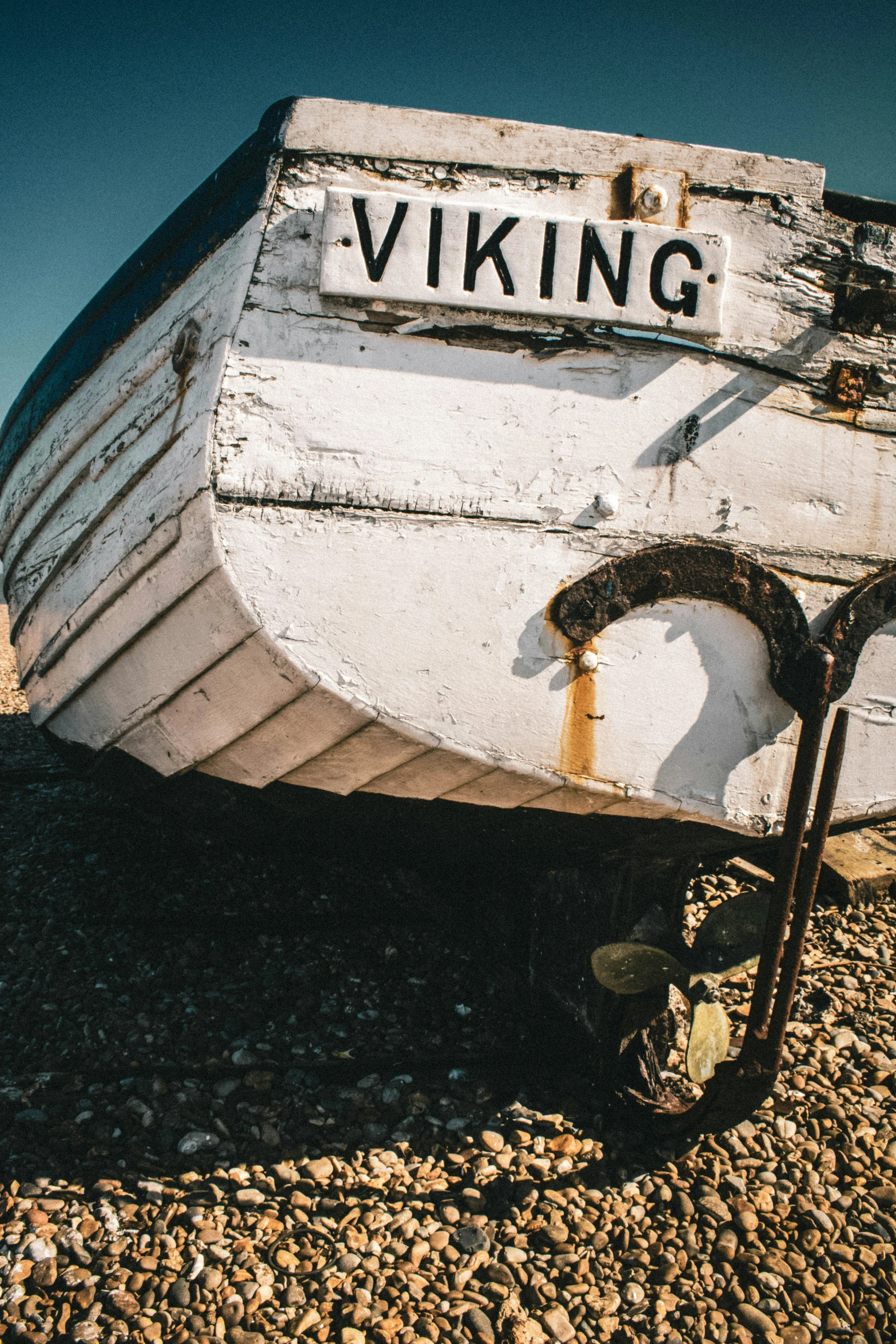 a wooden boat sits on the shore