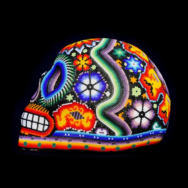 a painted skull with bright, colorful, and psychedelically patterns on it