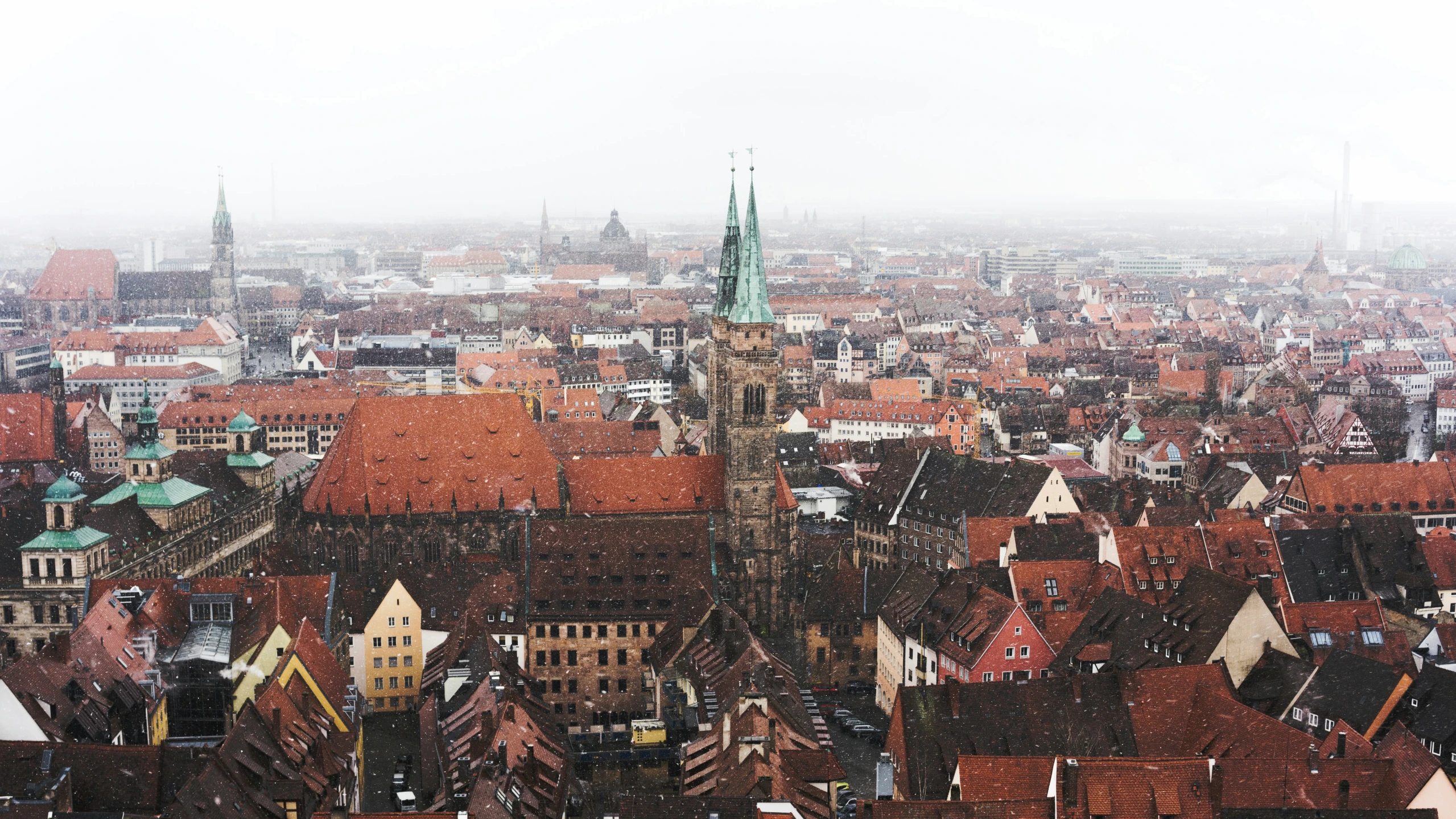 a tall building is shown with some red roofs