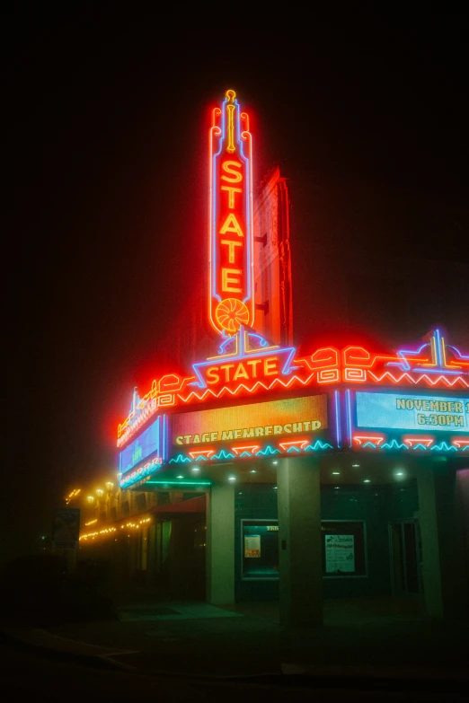 a theater with colorful lights on the front