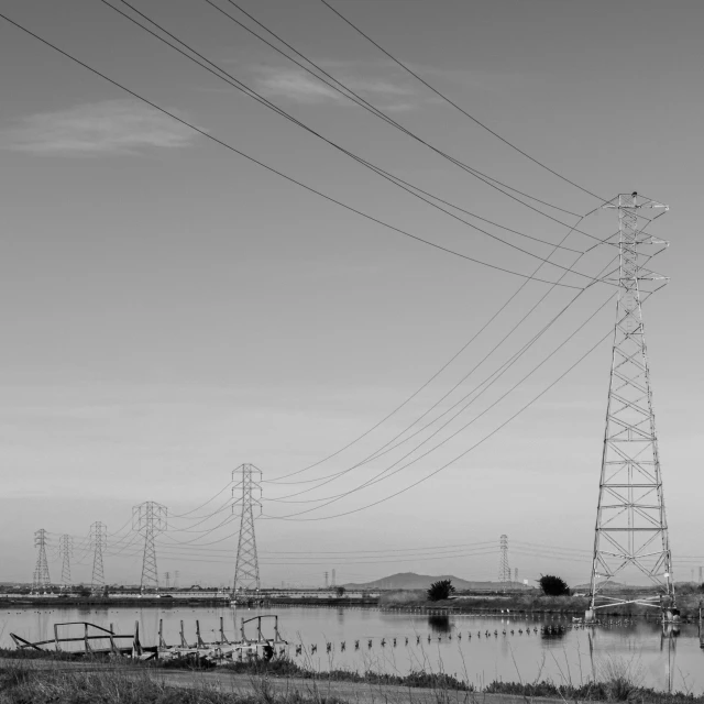 power lines by the river in black and white