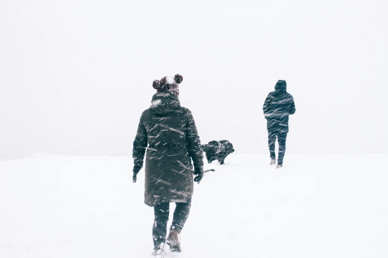 people walking on the snow during a very cold day