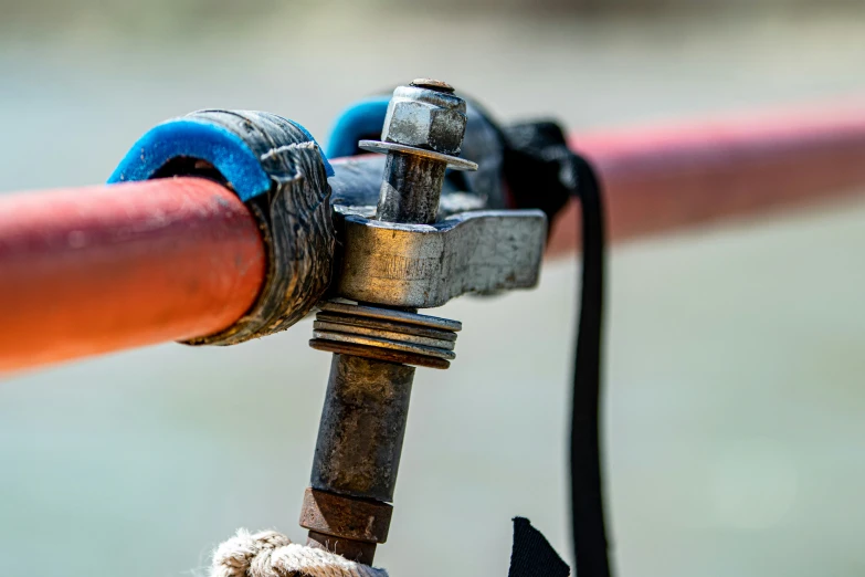 a teddy bear between a spigot and pipe