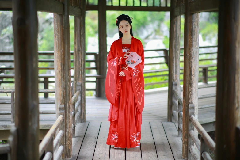 a woman in red with a white bird on her hand