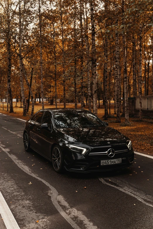 a mercedes benz is parked on the side of a road