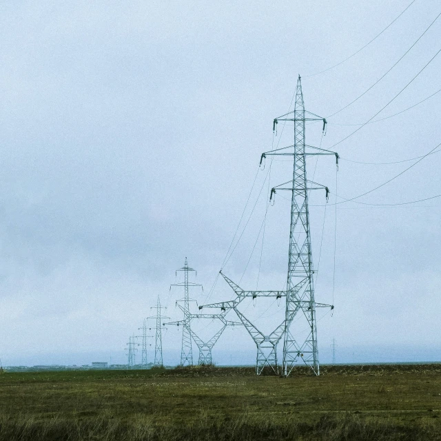 a large power pole standing in an open field