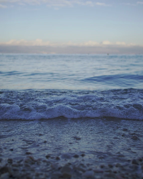 blue ocean waves crashing on sandy beach