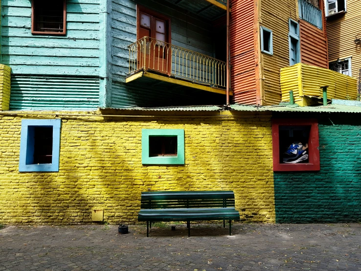 a bench near colorful buildings on a sunny day