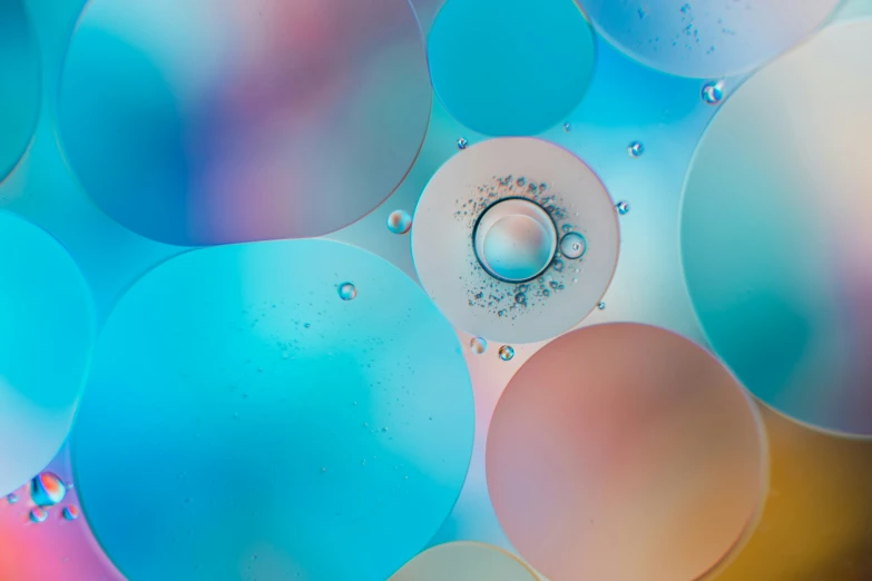 closeup s of bubbles of different colors on plastic with an open valve