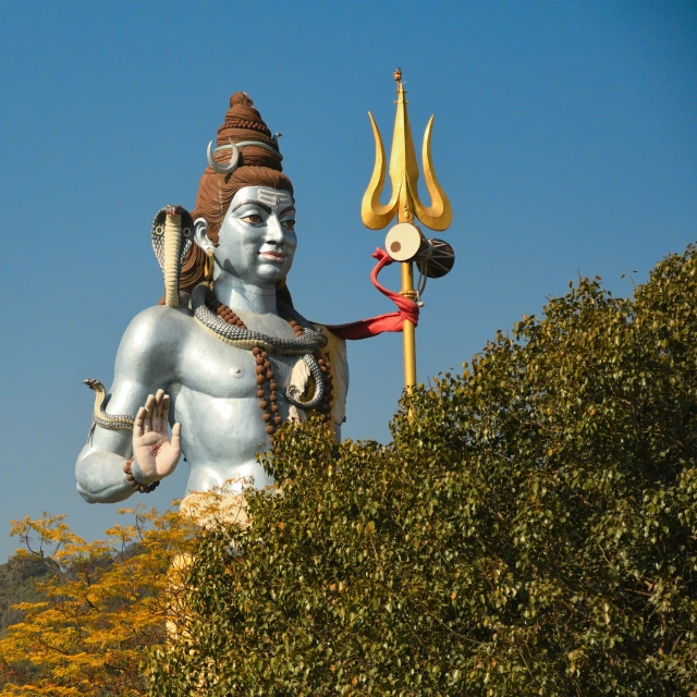 there is a statue made of cement in the shape of a god