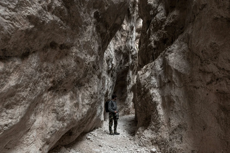 a man that is standing in the middle of a ravine