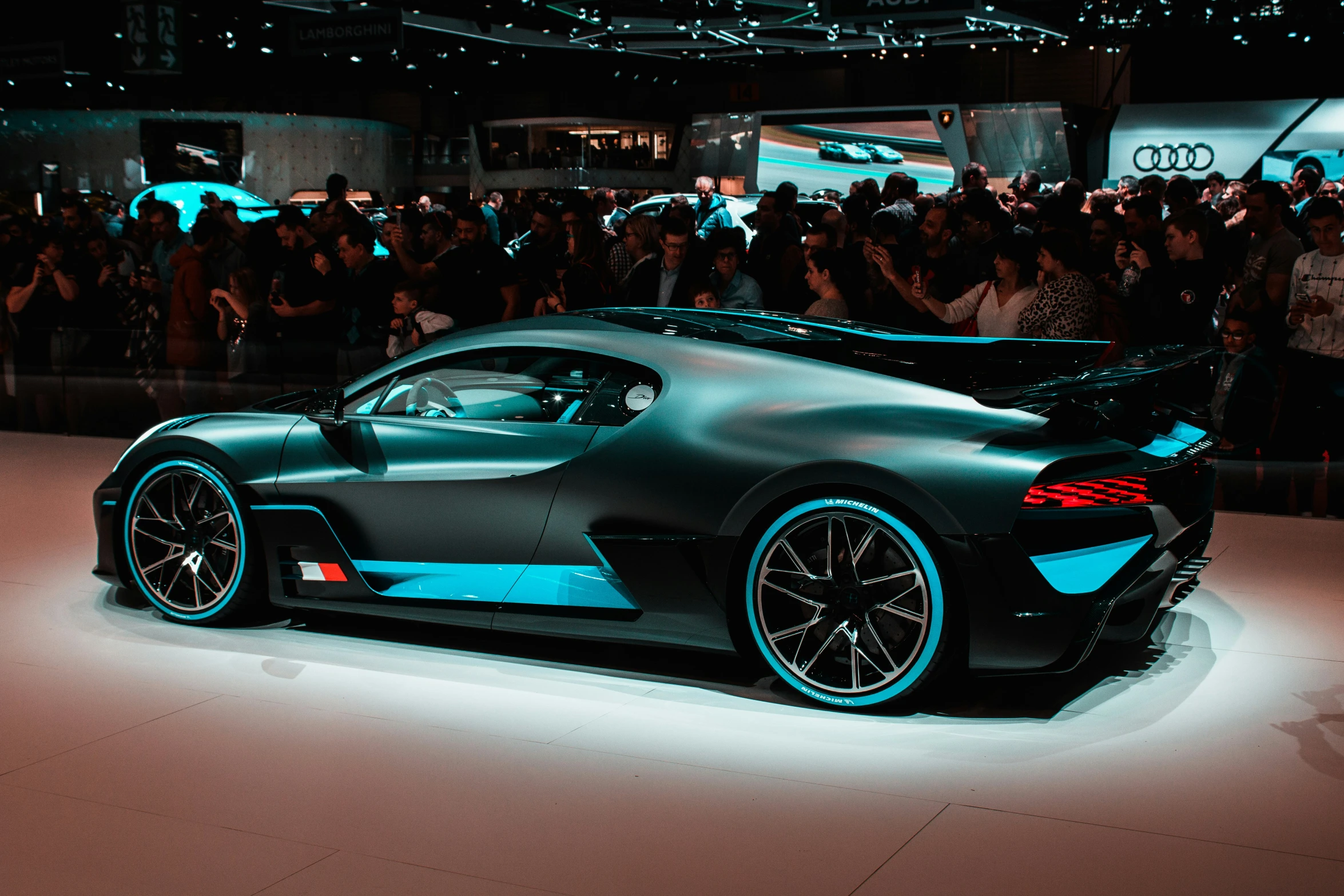 people at a car show watching a mercedes race car