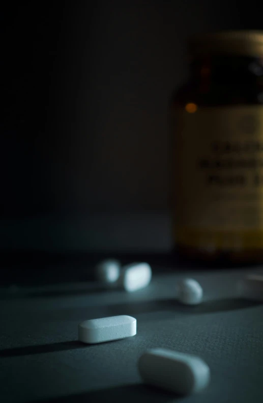 an empty prescription bottle next to a pill pill