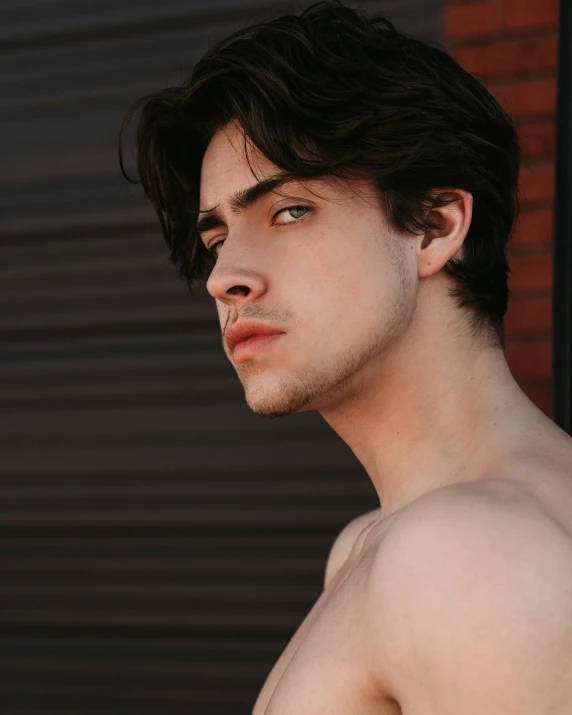 a man posing shirtless in a red and white  shirt