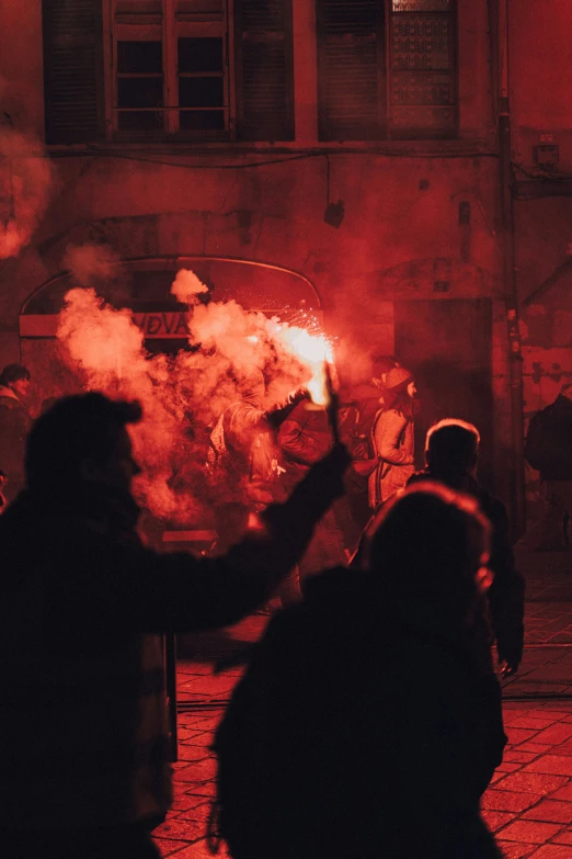 some people standing in front of a big pile of smoke