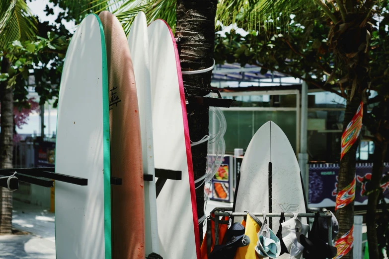 a view of a rack full of surfboards on a sidewalk