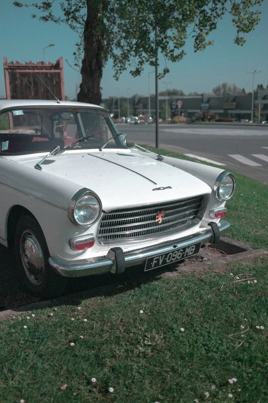 the car is parked in the grass by the street