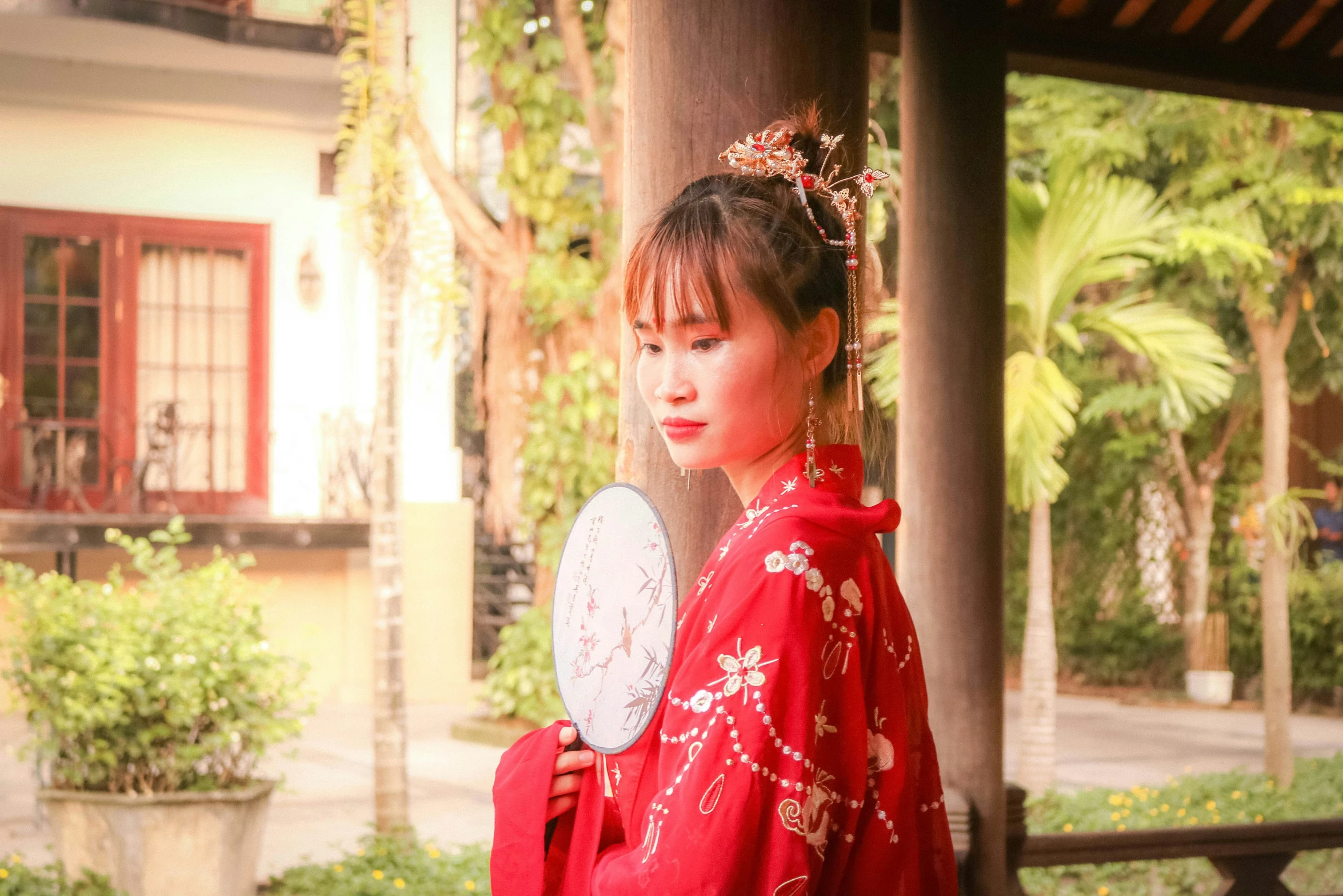 a woman in a kimono, holding a frisbee