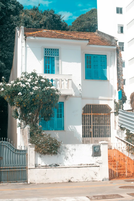 a white building with blue shutters and windows