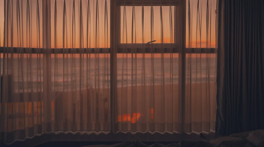 the view of the ocean from inside a bedroom