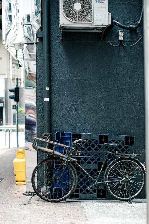 a bicycle  to a metal pole on the street