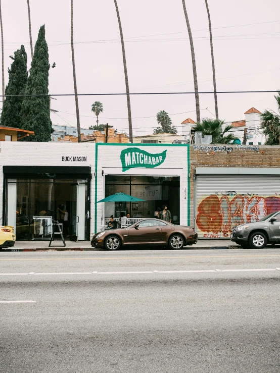 a group of cars that are parked outside of a store