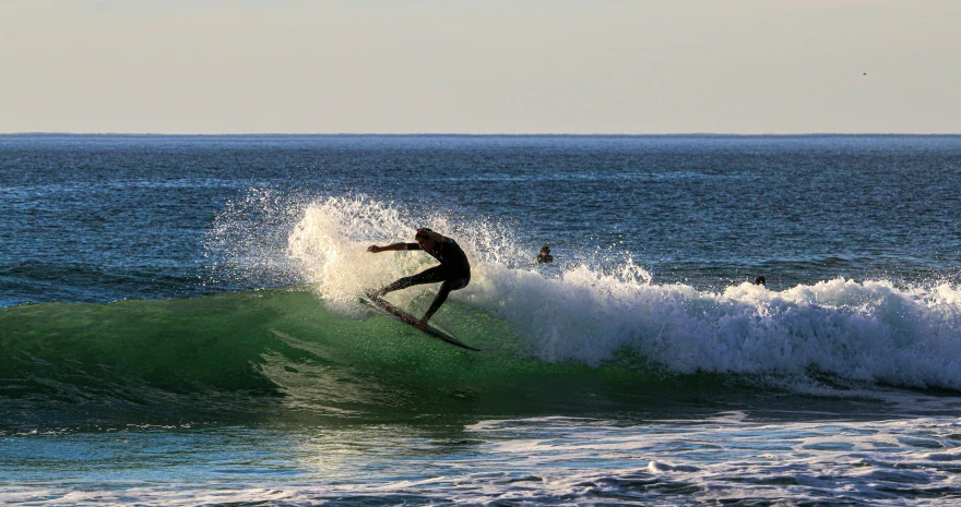 the surfer is in the middle of the huge wave