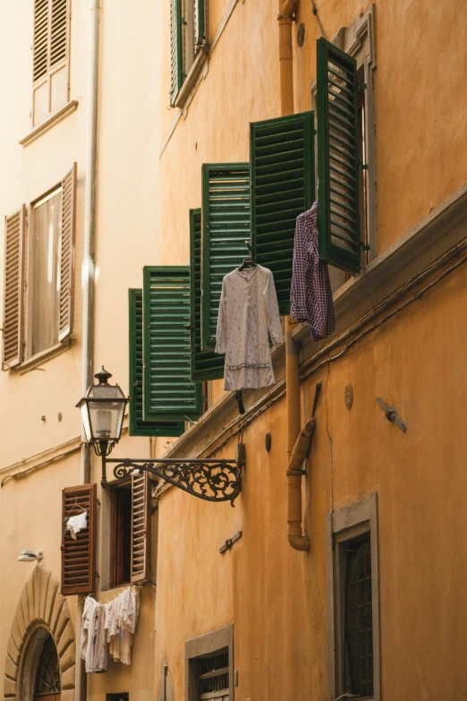 a couple of men's shirts are hung on the clothesline