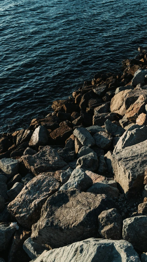 a view of a body of water through some rocks