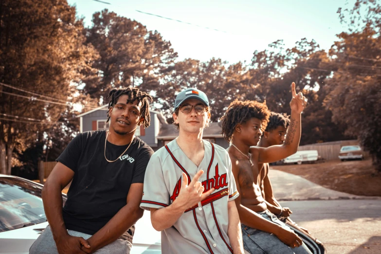 three young men with no one around them posing together