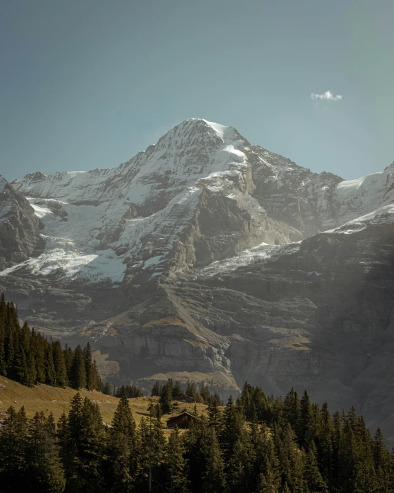 a group of people hiking towards snow covered mountains