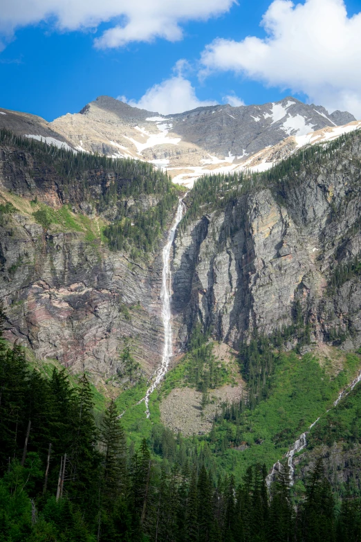 a long waterfall going through the side of a mountain