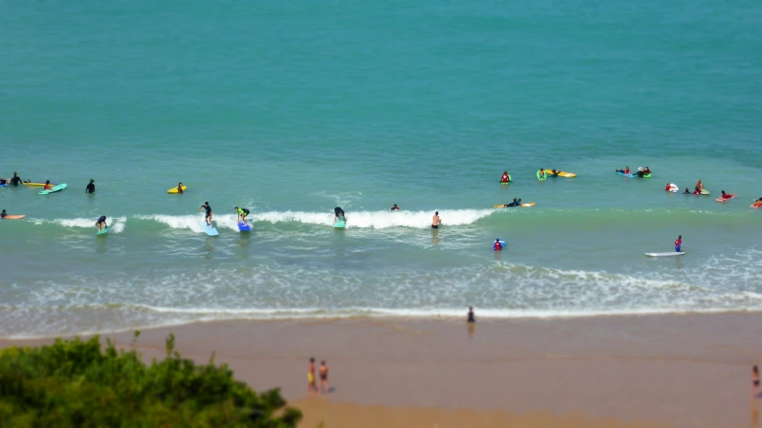 surfers and swimmers are standing in the ocean water