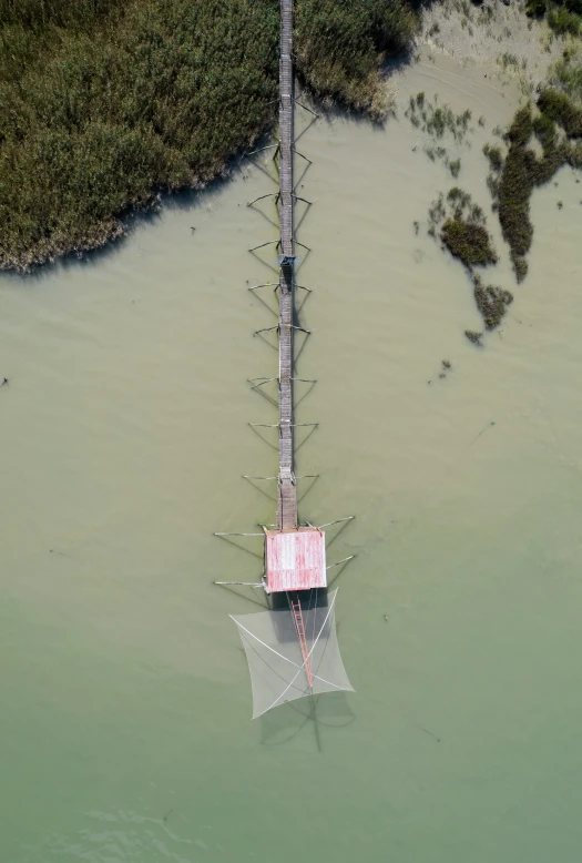 an aerial view of a boat in a body of water