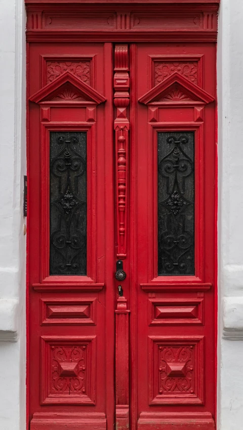 an image of a red door with a clock on the side